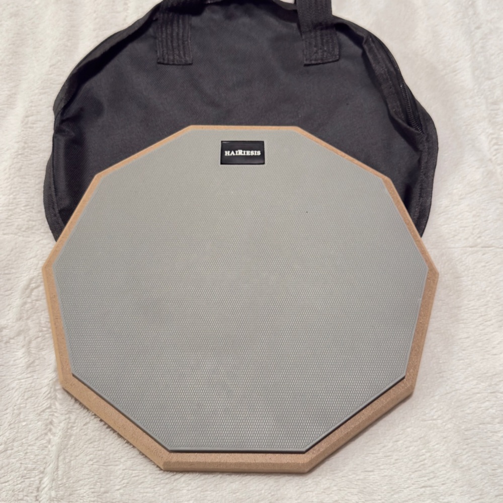 Snare practice drum, Vic Firth drumsticks, and a music stand